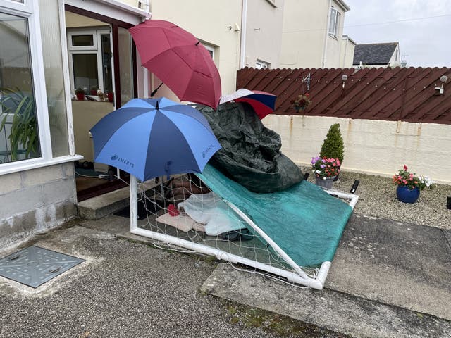 <p>The man’s family were forced to build a shelter to protect him from the rain </p>