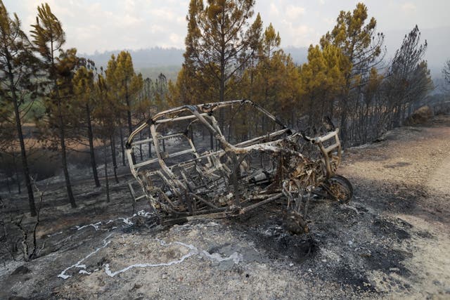 <p>The wreckage of a car burned by a forest fire in Bejis, Spain, on 17 August, 2022.</p>