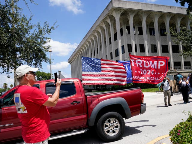 <p>A vehicle with flags in support of Donald Trump drives outside of the Paul G. Rogers Federal Courthouse, Thursday, Aug. 18, 2022, in West Palm Beach, Fla</p>