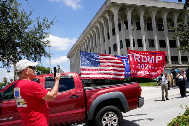 <p>A vehicle with flags in support of Donald Trump drives outside of the Paul G. Rogers Federal Courthouse, Thursday, Aug. 18, 2022, in West Palm Beach, Fla</p>