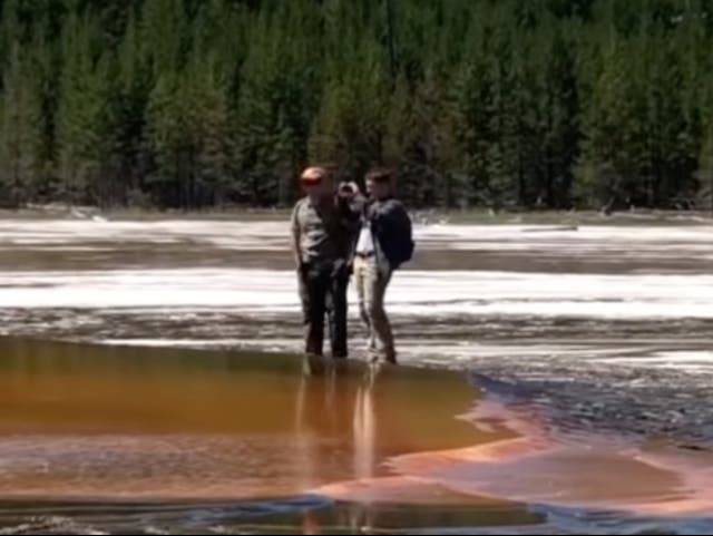 <p>Tourists at Yellowstone National Park’s Grand Prismatic Geyser leave the trail and risk death to grab photos up close</p>