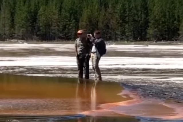 <p>Tourists at Yellowstone National Park’s Grand Prismatic Geyser leave the trail and risk death to grab photos up close</p>
