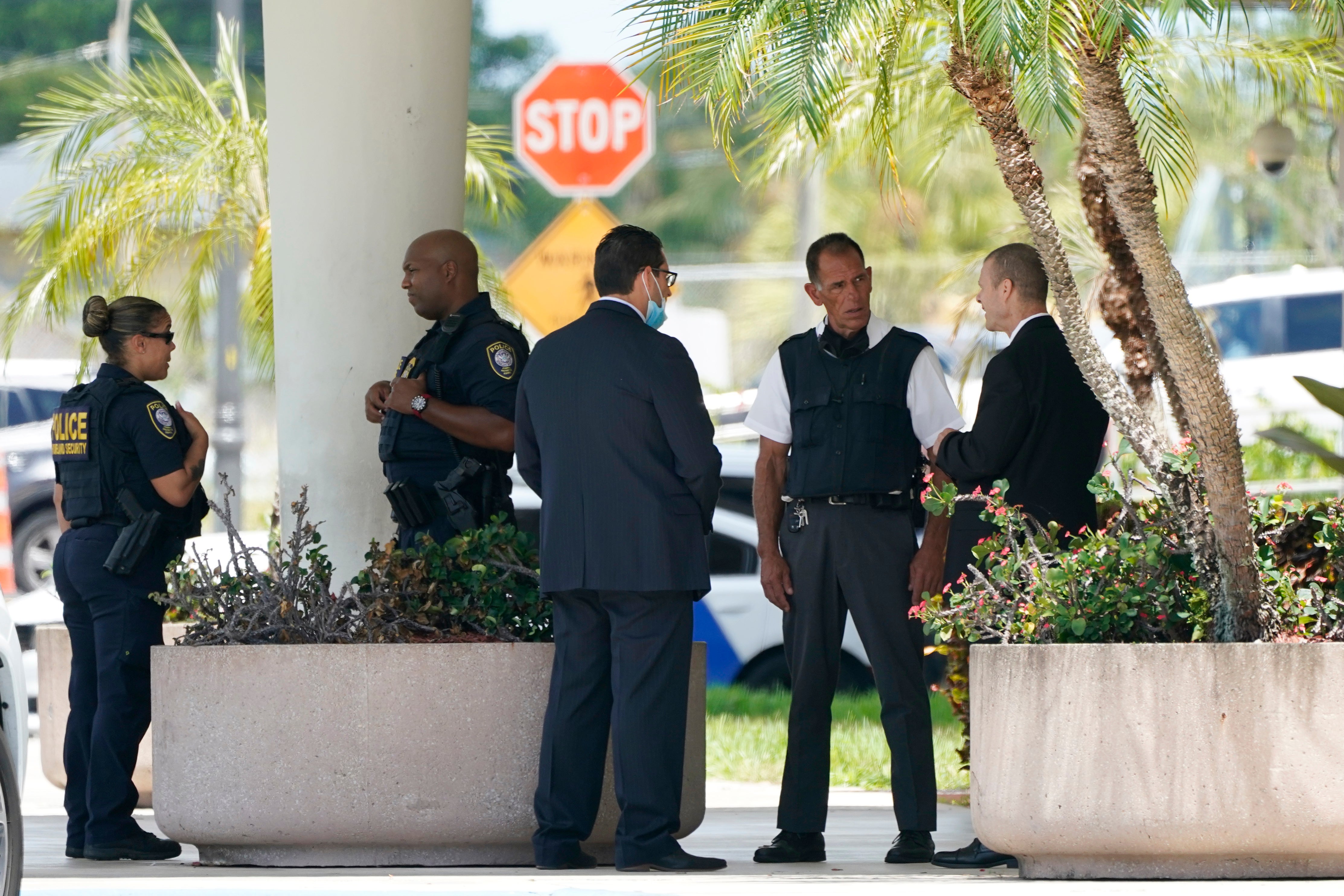 Law enforcement stands outside of the Paul G. Rogers Federal Courthouse, Thursday, Aug. 18, 2022, in West Palm Beach, Fla