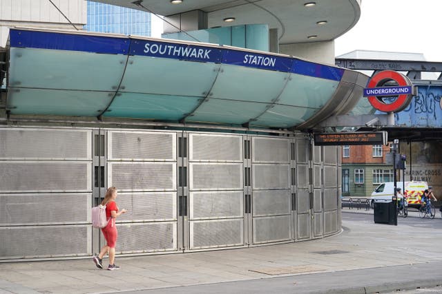 A woman walks past Southwark Station, closed due to strike action (Dominic Lipinski/PA)