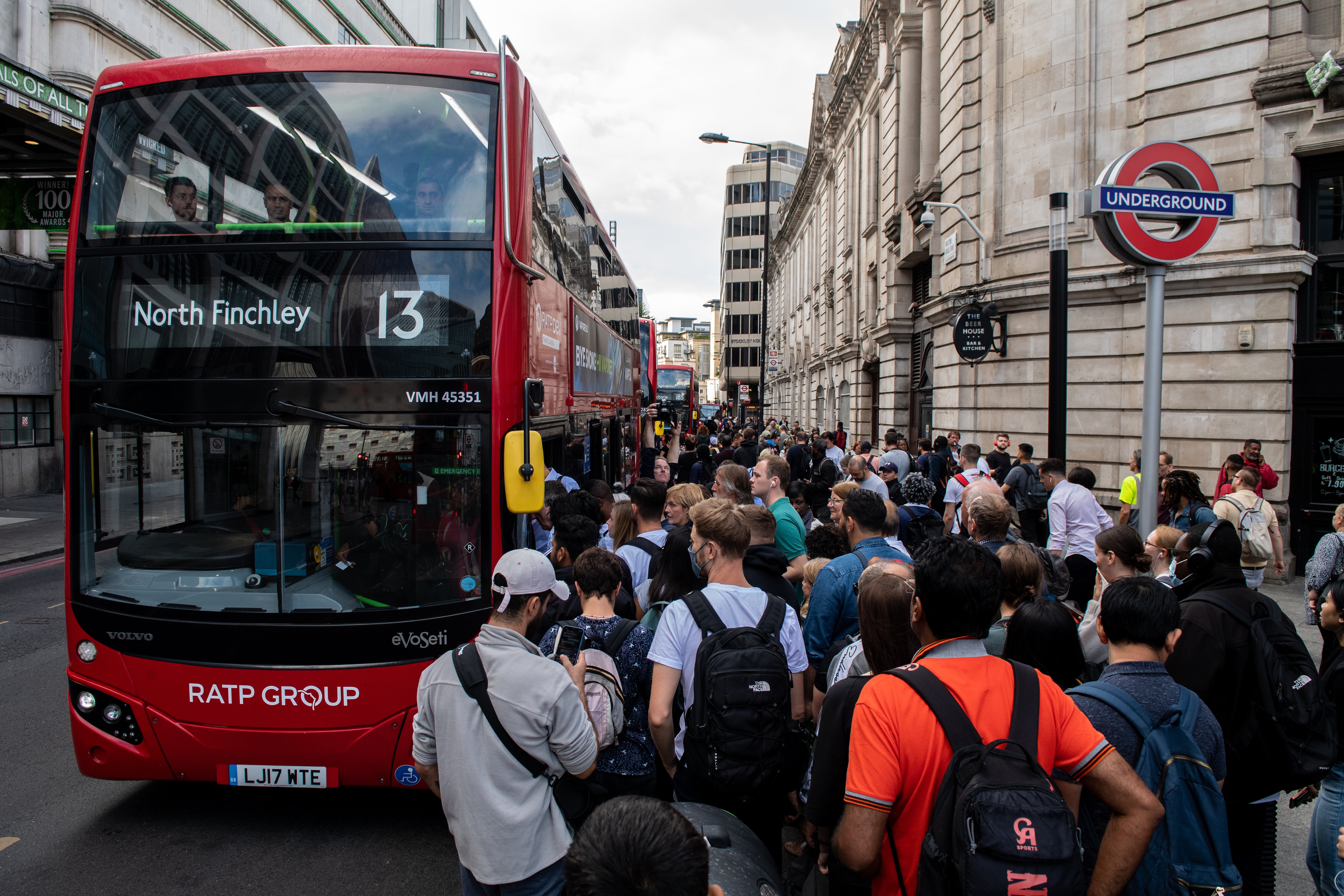 File photo: People queue for buses during a previous strike