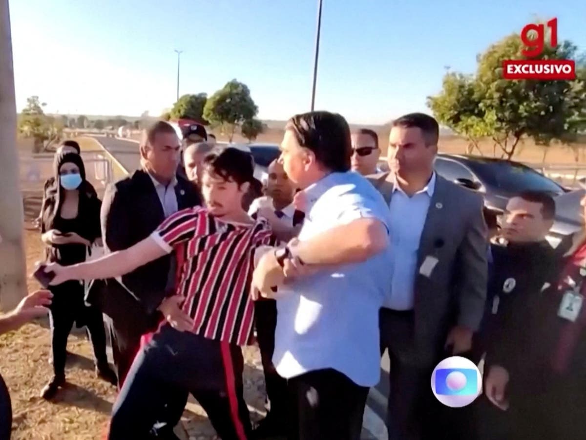 Brazil&rsquo;s president Jair Bolsonaro grabs at heckler and tries to snatch his phone