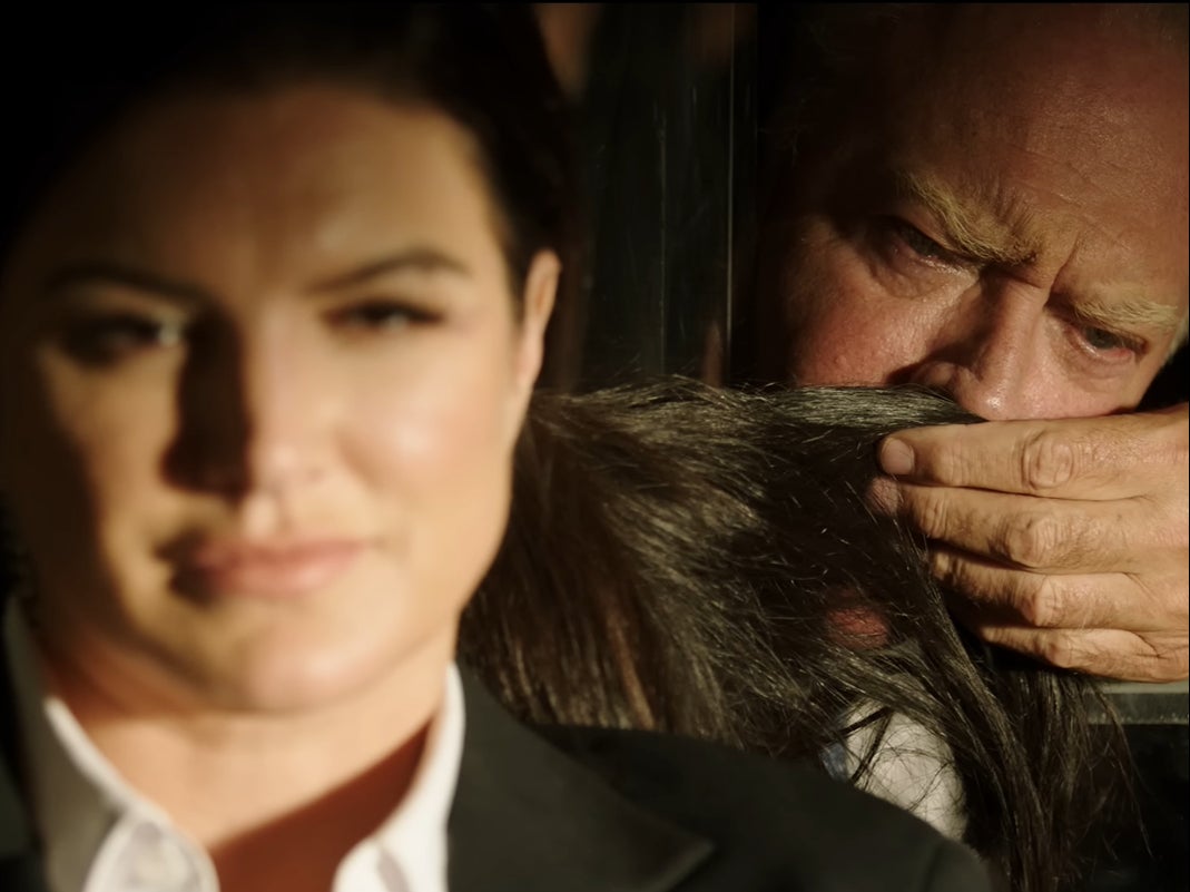 A secret service agent (Gina Carano) has her hair sniffed by Joe Biden (John James) in ‘My Son Hunter’