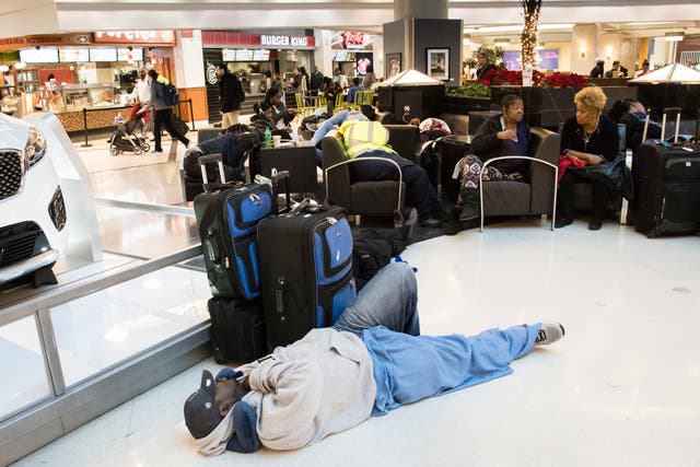 <p>A man sleeps on the floor in Atlanta’s airport </p>