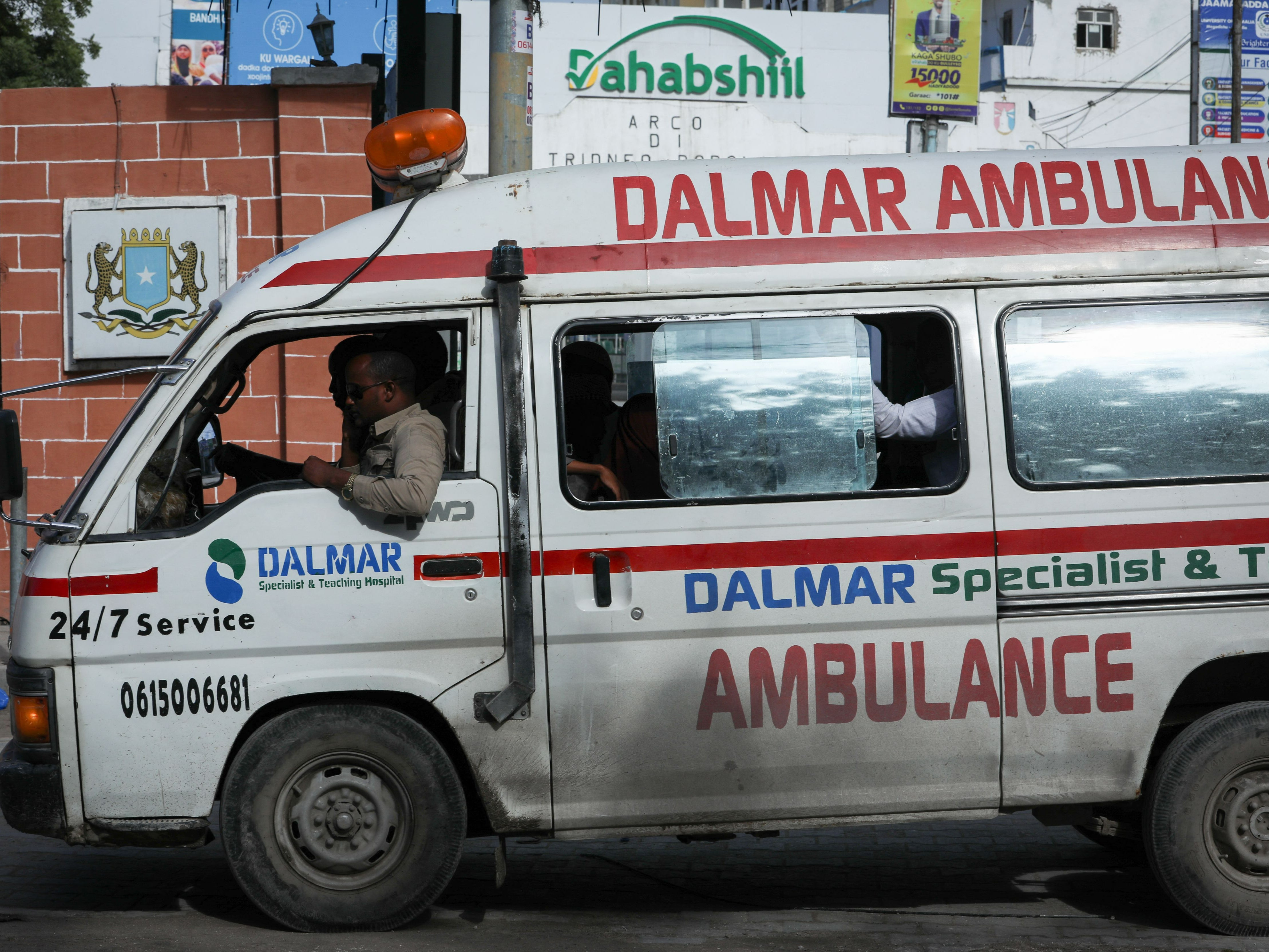 An ambulance is seen near the site of explosions in Mogadishu, on 20 August