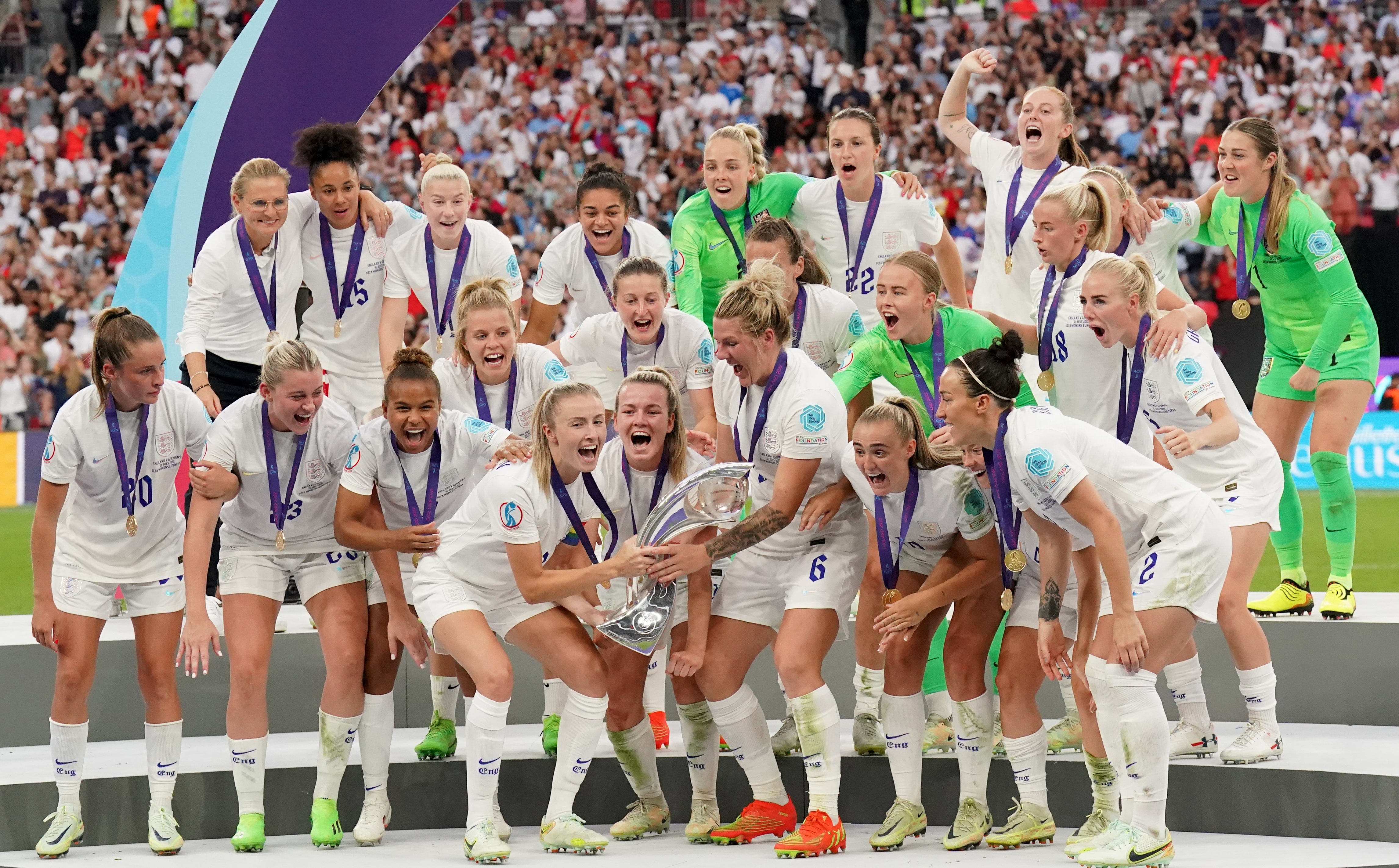 England’s Leah Williamson and Millie Bright lift the Euro 2022 trophy (Jonathan Brady/PA)
