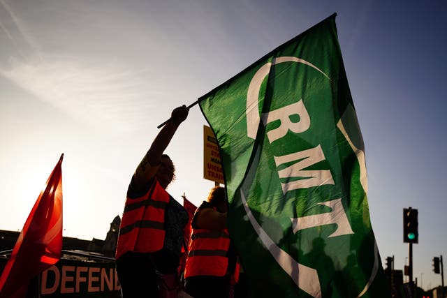 <p>Members of the Rail, Maritime and Transport union (RMT) on the picket line outside Bristol Temple Meads station as union members take part in a strike over pay and conditions</p>