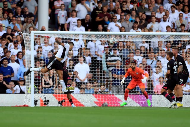 <p>Mitrovic guides his header past Brentford goalkeeper David Raya to claim all three points for Fulham </p>