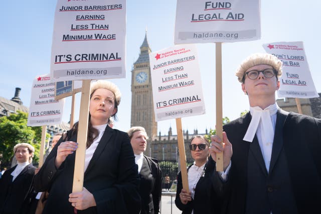 <p>Criminal defence barristers outside the Houses of Parliament in London as they support the ongoing Criminal Bar Association (CBA) action over Government set fees for legal aid advocacy work (Stefan Rousseau/PA)</p>