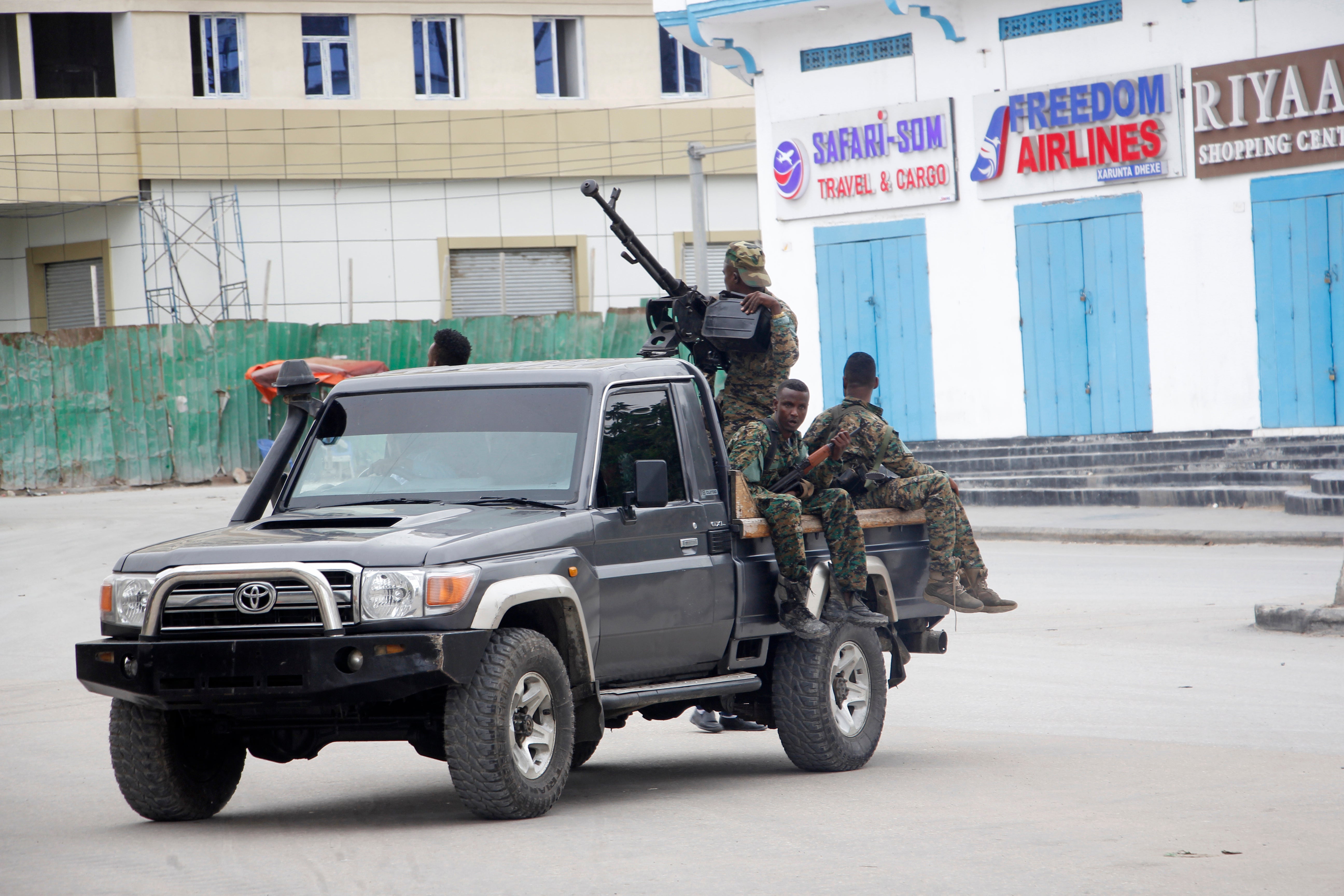 Soldiers patrol outside the Hayat Hotel in Mogadishu on 20 August