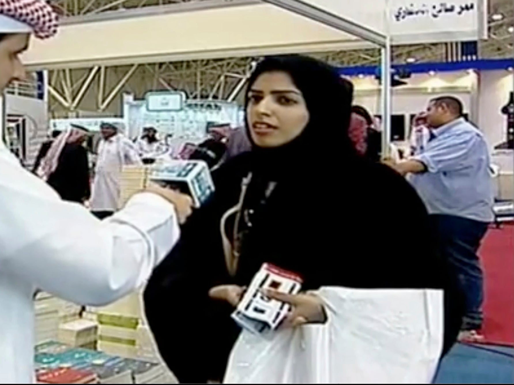 Salma al-Shehab, pictured here speaking to a journalist at Riyadh International Book Fair, has been jailed for 34 years in Saudi Arabia
