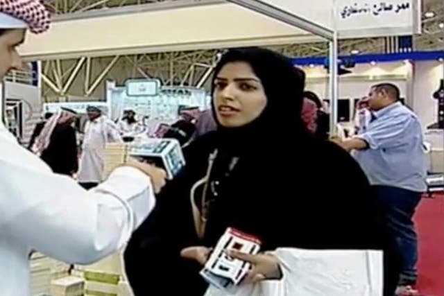 <p>Salma al-Shehab, pictured here speaking to a journalist at Riyadh International Book Fair, has been jailed for 34 years in Saudi Arabia</p>