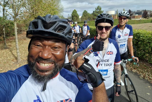 Festus Akinbusoye completing the cycle with fellow team members (Festus Akinbusoye/PA)
