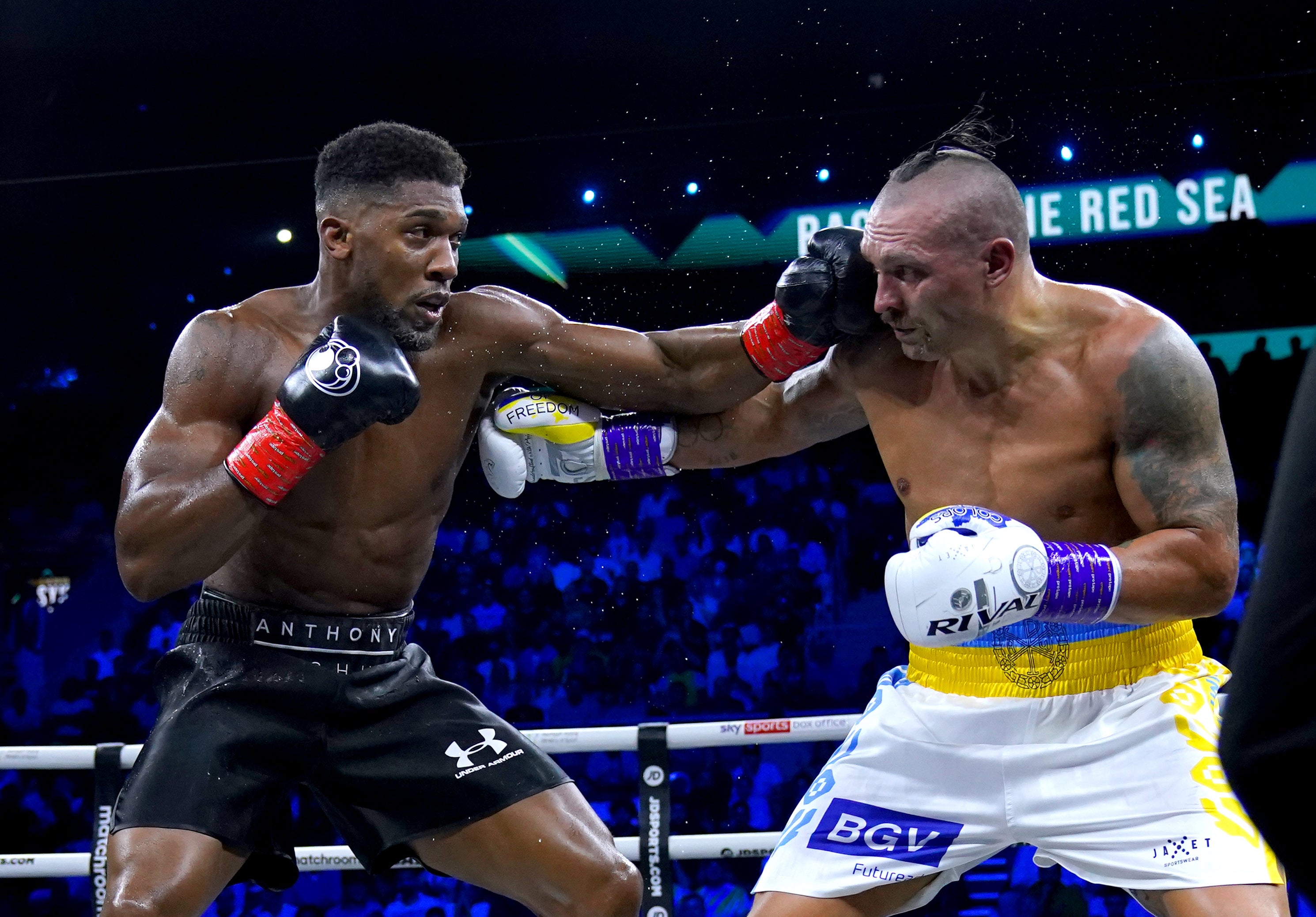 Anthony Joshua, left, and Oleksandr Usyk in action during their world heavyweight fight in Saudi Arabia (Nick Potts/PA)