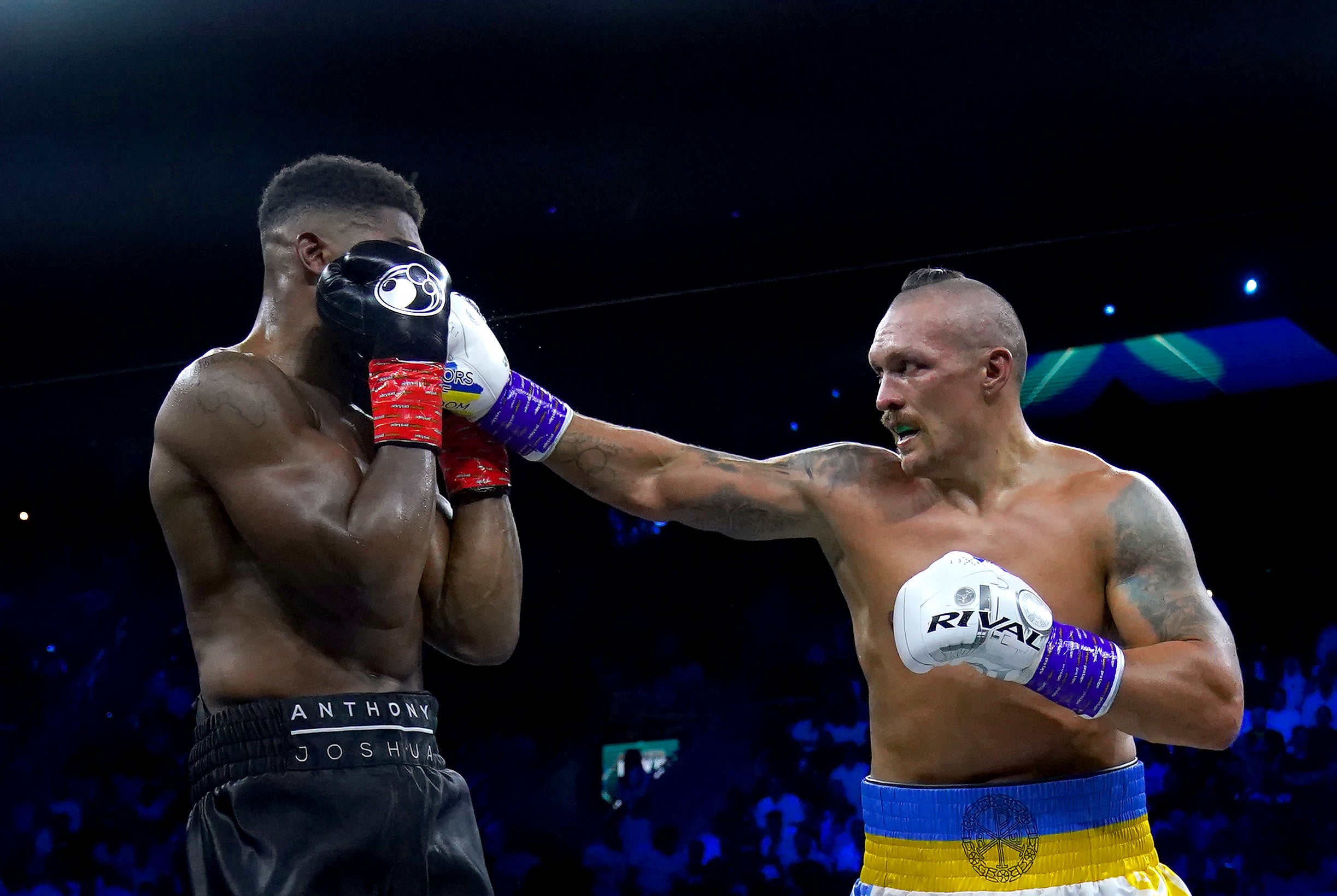 Anthony Joshua, left, and Oleksandr Usyk in action (Nick Potts/PA)