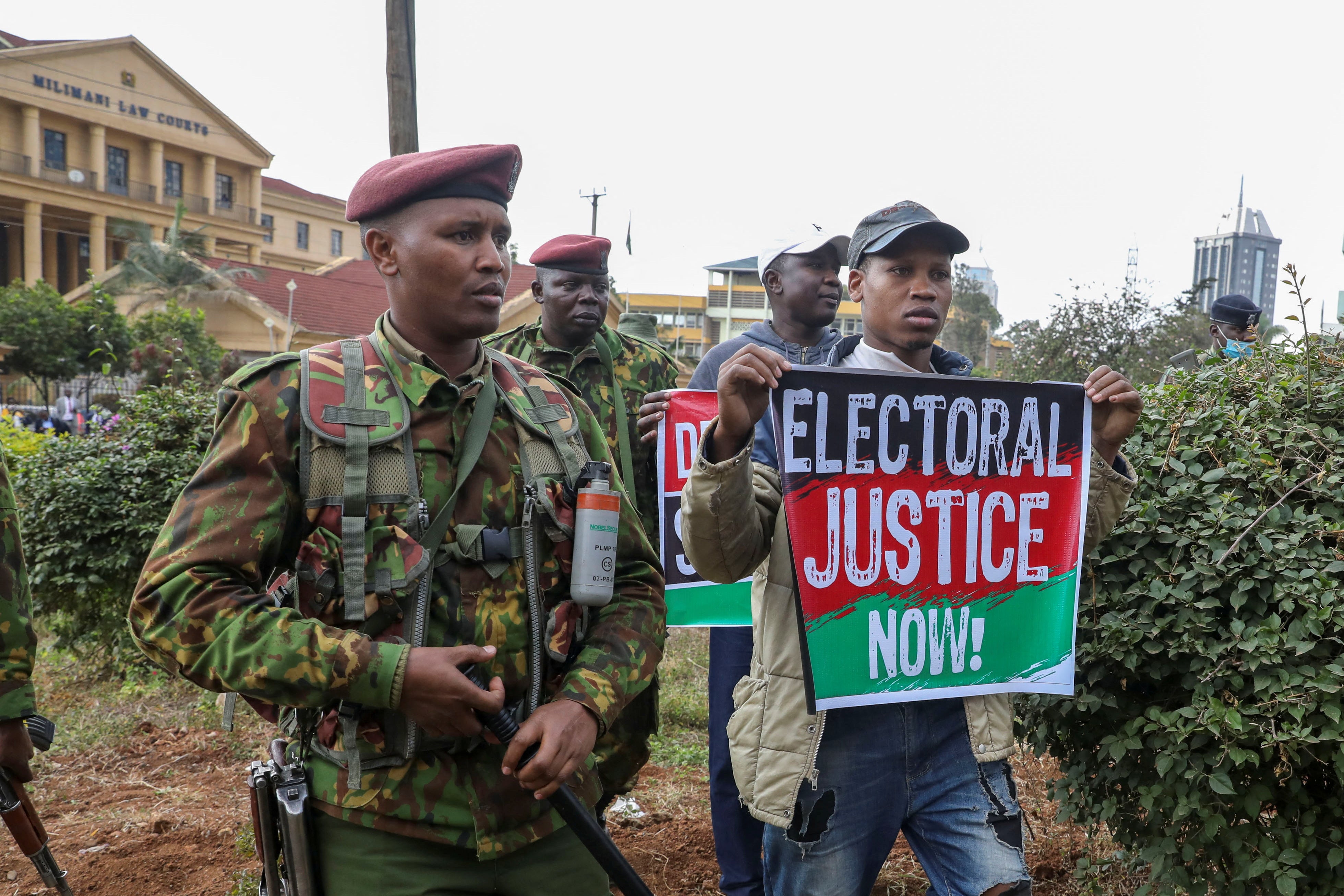 Supporters of Kenya’s opposition leader gather as police officers keep guard