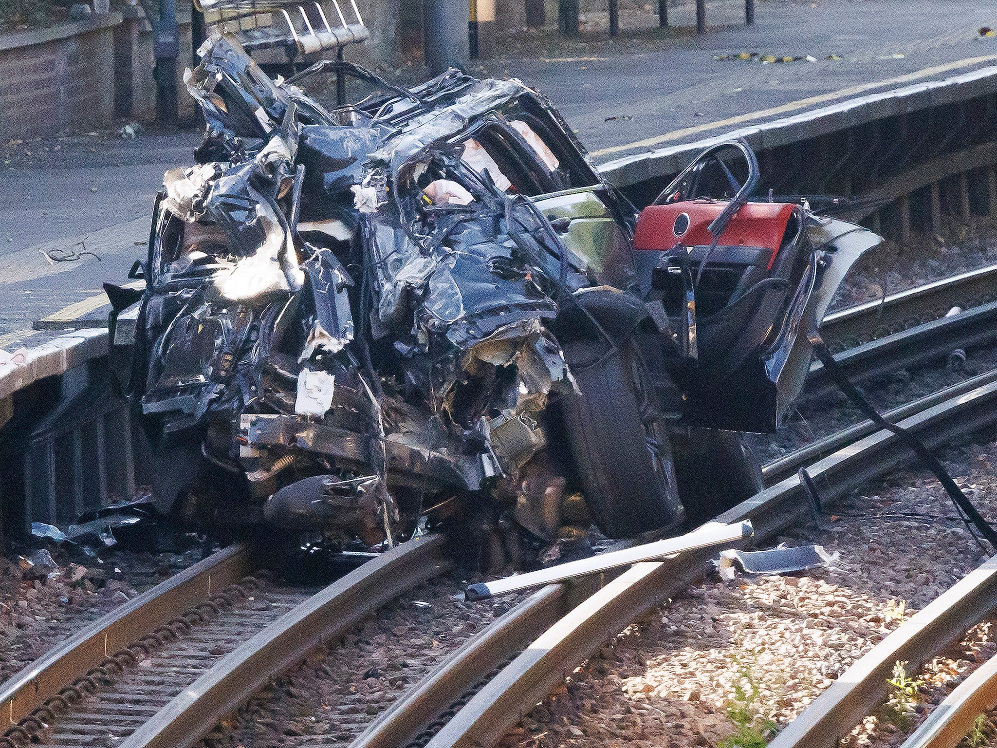 Woman dies in crash that leaves Range Rover on railway…