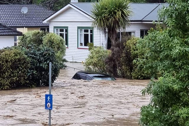 <p>A car is inundated by floodwater in central Nelson, New Zealand</p>