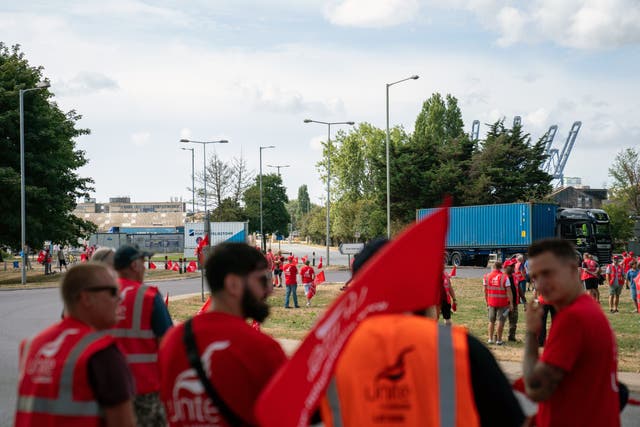 Members of the Unite union man a picket line at one of the entrances to the Port of Felixstowe (Joe Giddens/PA)