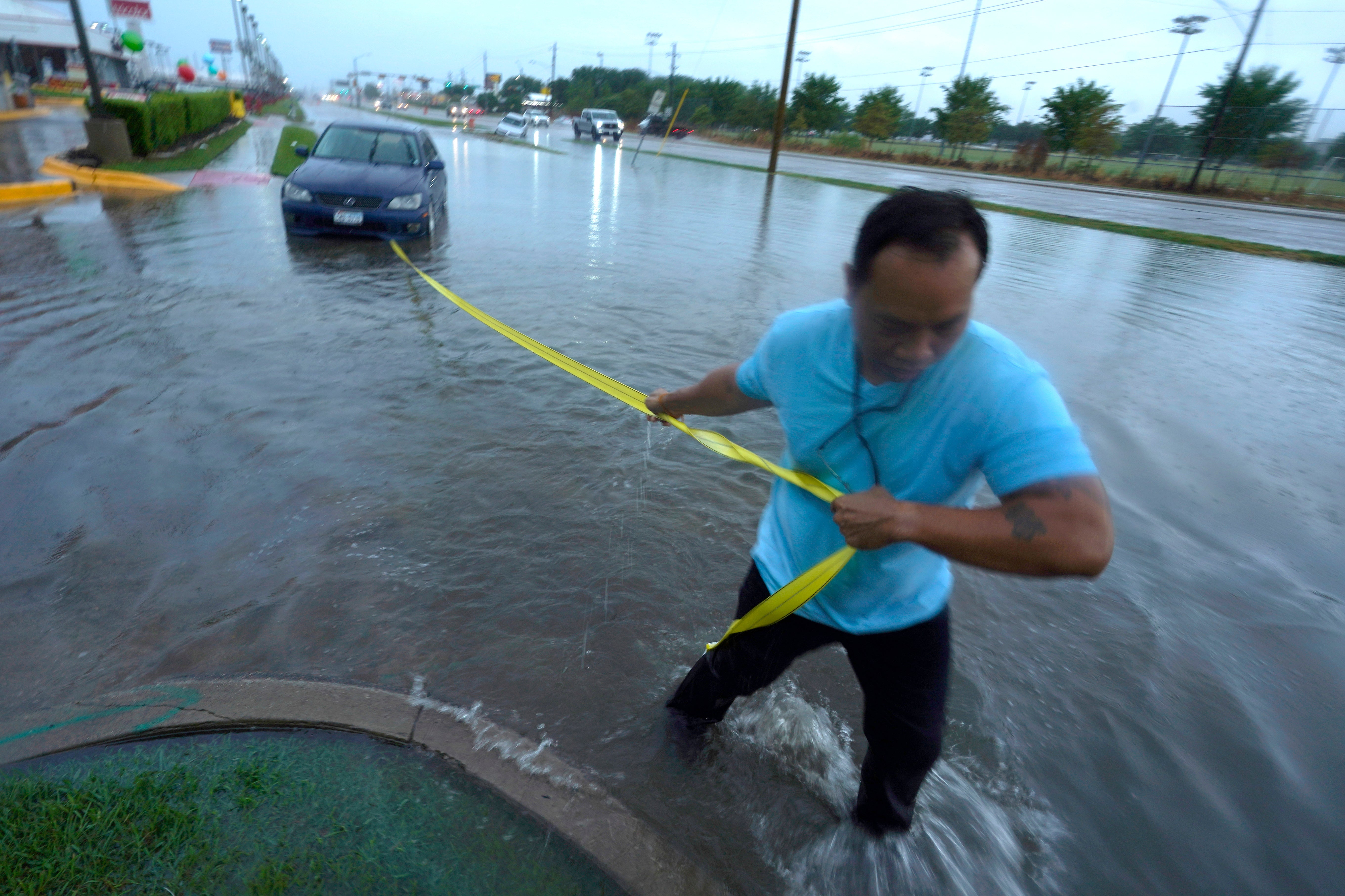 A man pulls his car out of floodwaters in Dallas, Texas on Monday