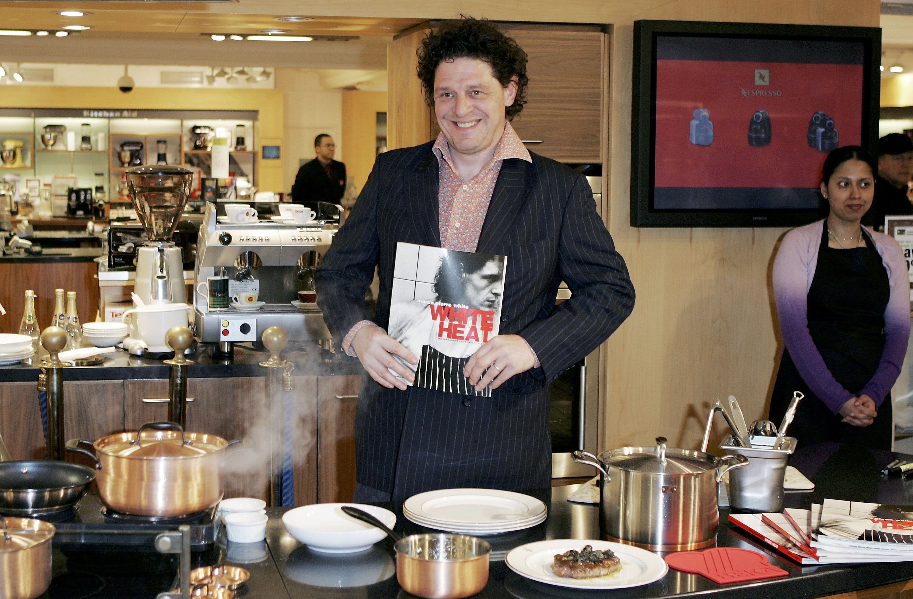 Marco Pierre White poses during the launch of his cookware, The White Heat Collection, with a copy of his book ‘White Heat’, on 8 April 2006 at Harrods in London, England