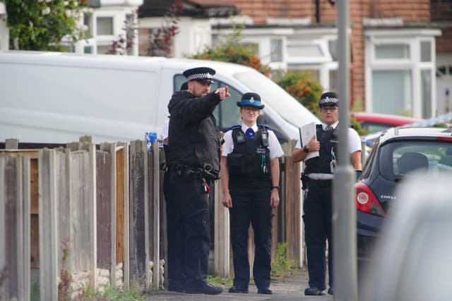 Police officers at the scene in Kingsheath Avenue, Knotty Ash, Liverpool, where a nine-year-old girl has been fatally shot. Officers from Merseyside Police have started a murder investigation after attending a house at 10pm Monday following reports that an unknown male had fired a gun inside the property. Picture date: Tuesday August 23, 2022.
