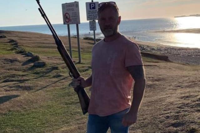 <p>Councillor Jon Scriven appearing to hold a firearm in Facebook post (Jon Scriven/Facebook/PA)</p>