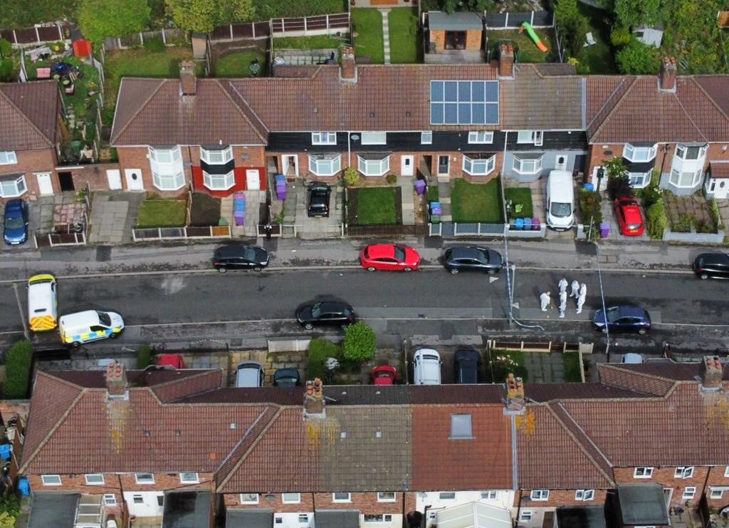 An aerial view of forensics officers at the scene