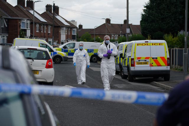 Forensic officers near to the scene in Kingsheath Avenue, Knotty Ash, Liverpool, where a nine-year-old girl has been fatally shot (Peter Byrne/PA)