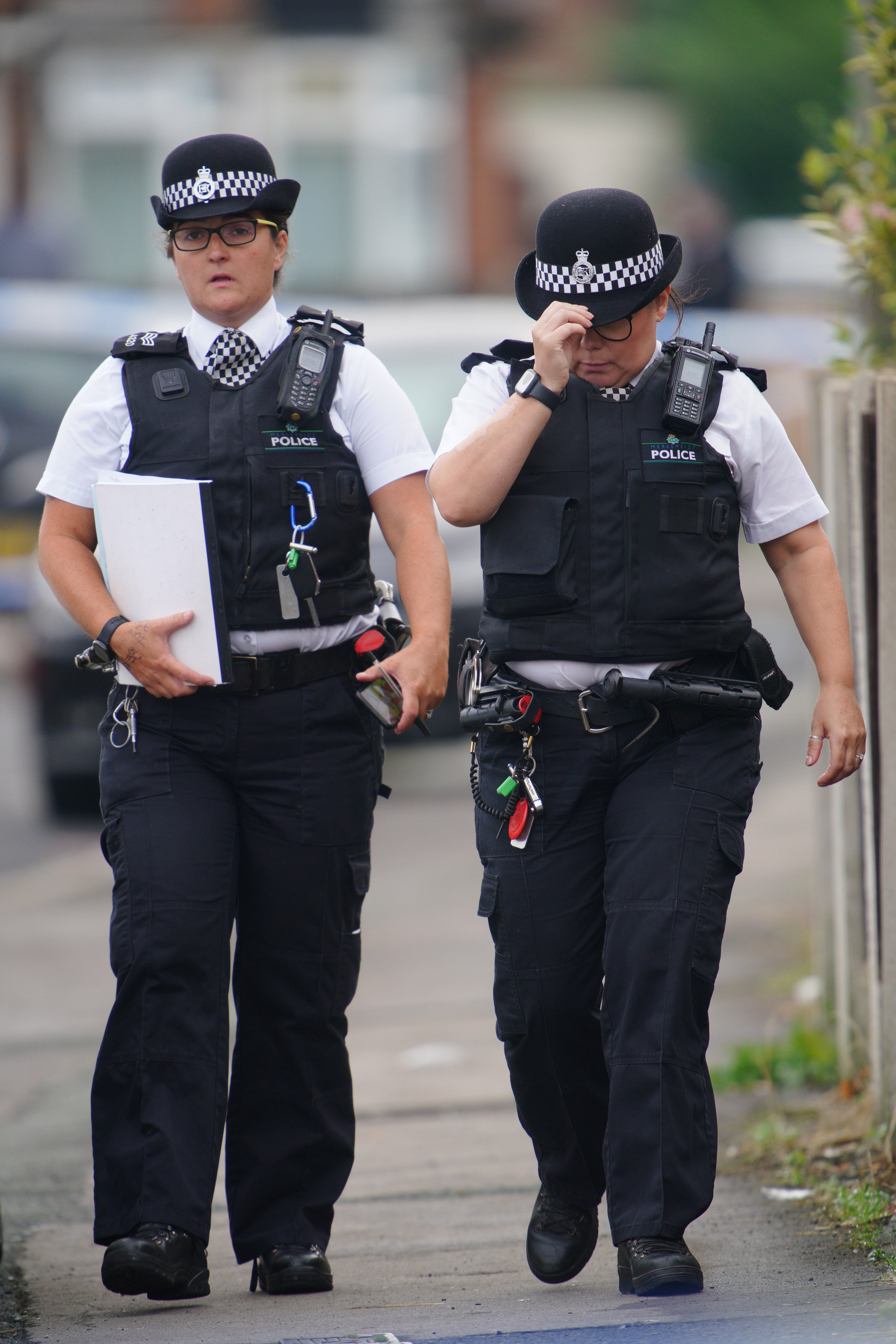 Police officers near to the scene in Kingsheath Avenue, Knotty Ash, Liverpool, where a nine-year-old girl was fatally shot (Peter Byrne/PA)