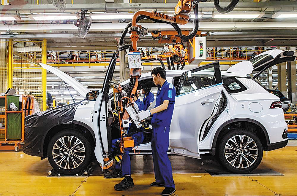 Workers assemble a vehicle on the production line at a plant of Chinese NEV manufacturer BYD in Xi’an, Shaanxi province, on July 5 2022