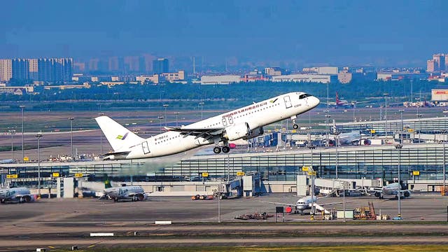 <p>A C919 passenger jet takes off for a test flight at Shanghai Pudong International Airport on May 14, 2022 </p>