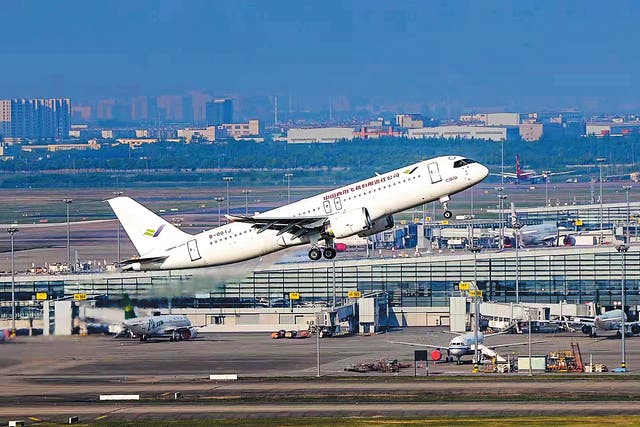 <p>A C919 passenger jet takes off for a test flight at Shanghai Pudong International Airport on May 14, 2022 </p>