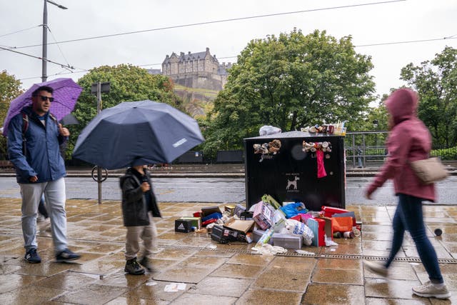 Bins along Princes Street in Edinburgh are overflowing with rubbish while cleansing workers take strike action (Jane Barlow/PA)