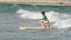Little girl trials new prosthetic arm helping her surf