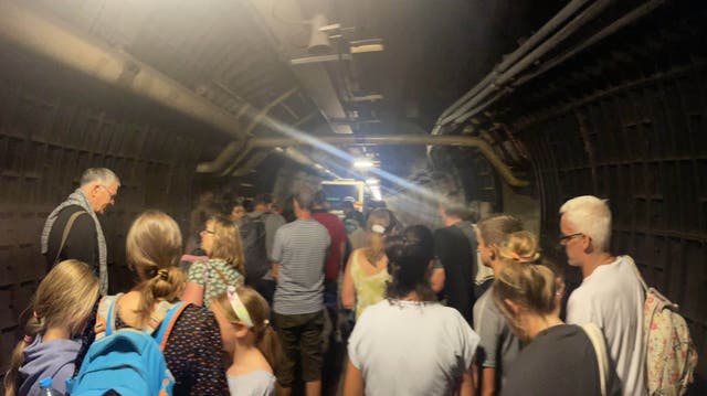<p>Passengers in the ‘service tunnel’ after a Calais-to-Folkestone shuttle came to a halt</p>