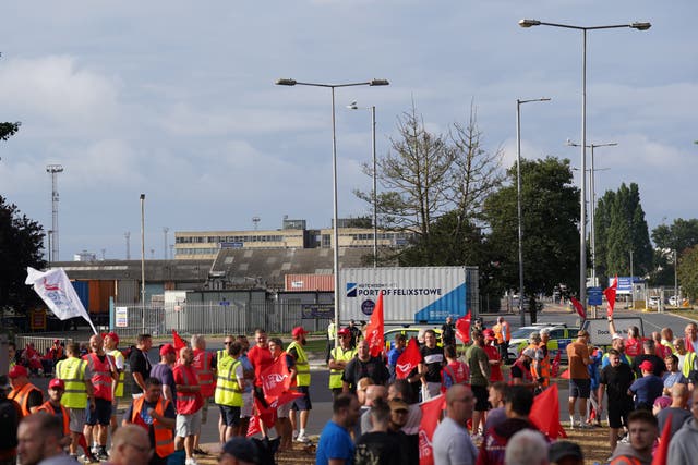 Members of the Unite union man a picket line at one of the entrances to the Port of Felixstowe in Suffolk, Britain’s busiest container port (Joe Giddens/PA)