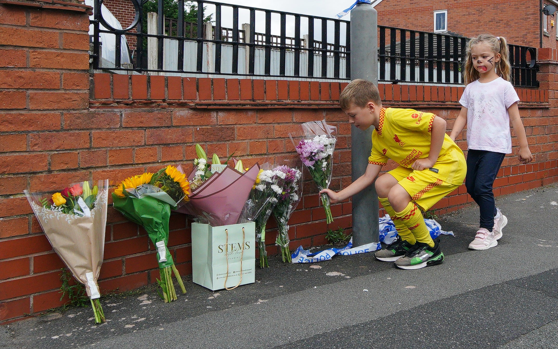 Children leave flowers near to the scene in Kingsheath Avenue, Knotty Ash, Liverpool, where nine-year-old Olivia Pratt-Korbel was fatally shot (Peter Byrne/PA)