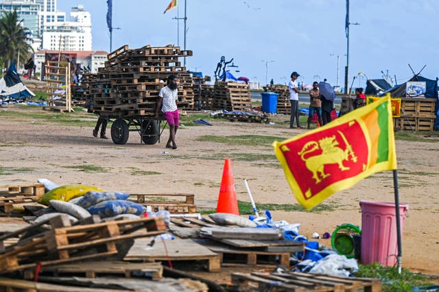 <p>Demonstrators prepare to leave the anti-government protest camp site near the Presidential Secretariat in Colombo</p>
