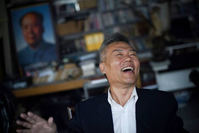 <p>File photo: Prominent social commentator Sima Nan laughing during an interview in Beijing</p>