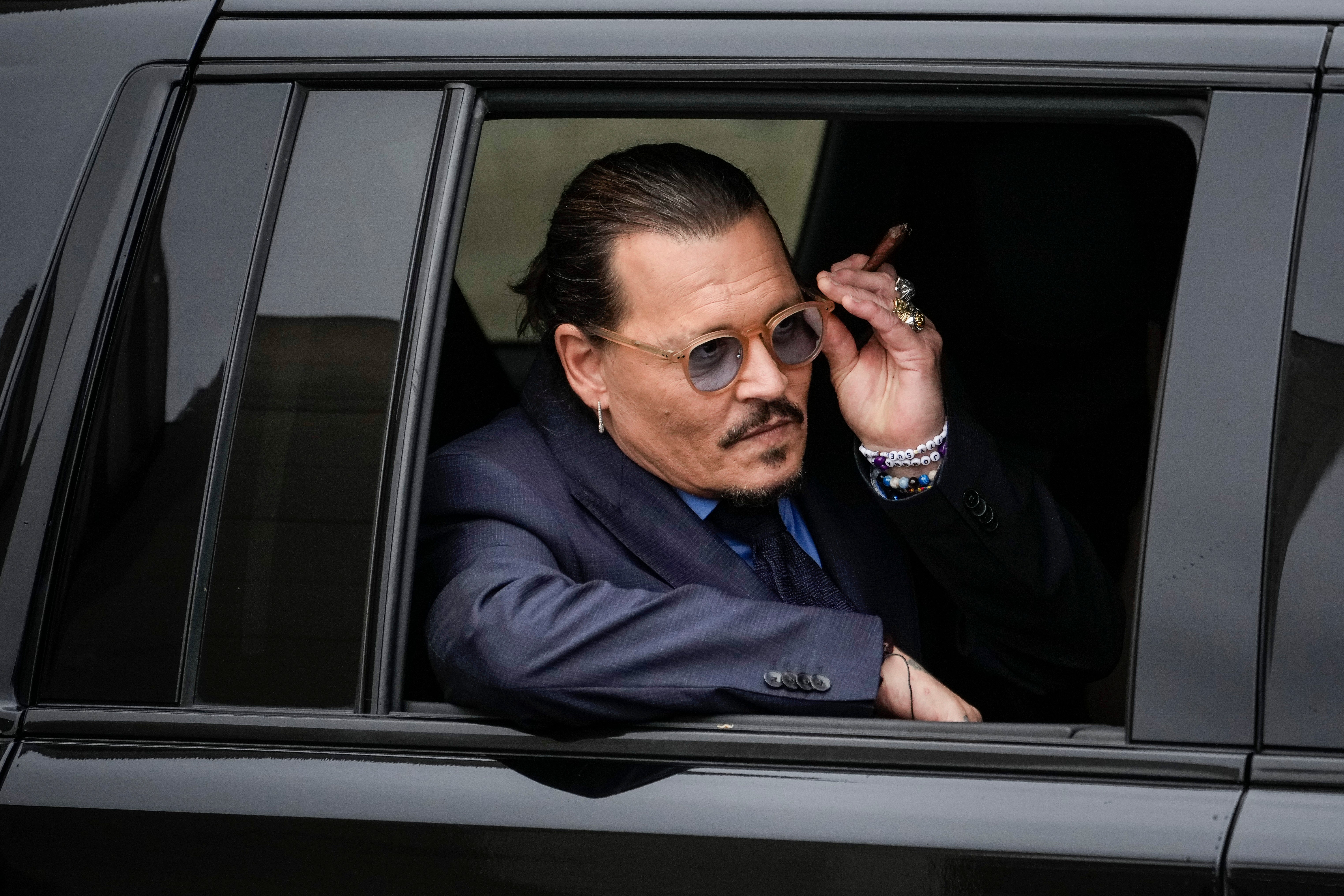 Depp leaving his trial in May