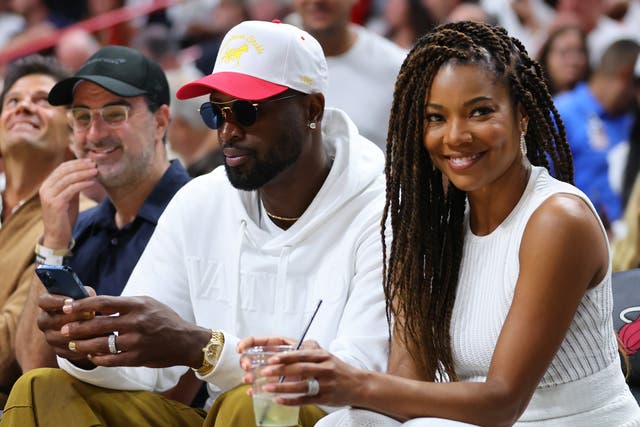 <p>Dwyane Wade and Gabrielle Union at a basketball game in May</p>