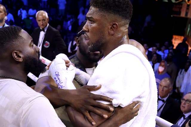 <p>Anthony Joshua’s team try to calm him down after his second straight loss to Oleksandr Usyk</p>