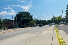 One dead and six injured after two gunmen jump out of car and ambush group of people in Baltimore street