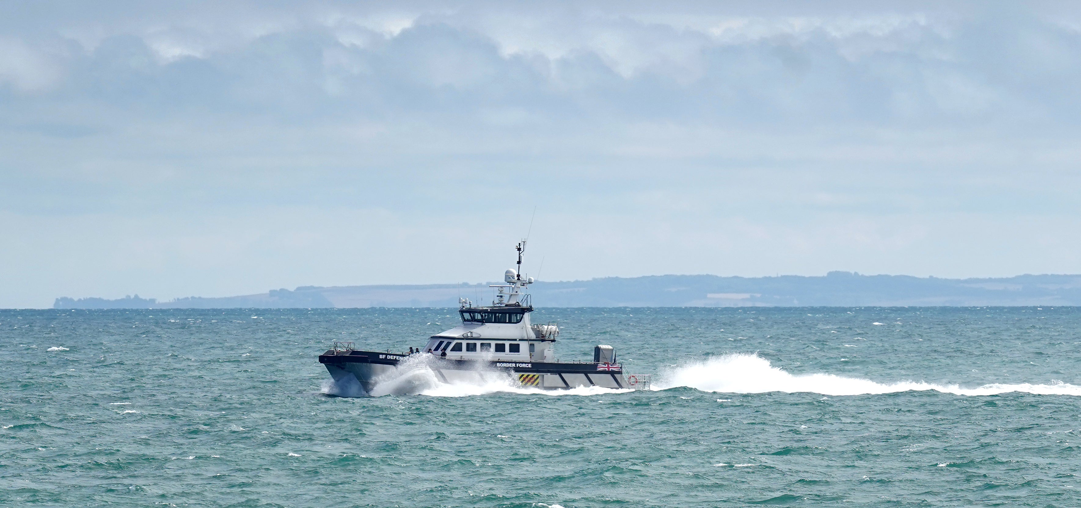 <p>Border Force vessel Defender carries a group of people thought to be migrants in to Dover, Kent, following a small boat incident in the Channel. Picture date: Tuesday August 23, 2022. (Gareth Fuller/PA)</p>