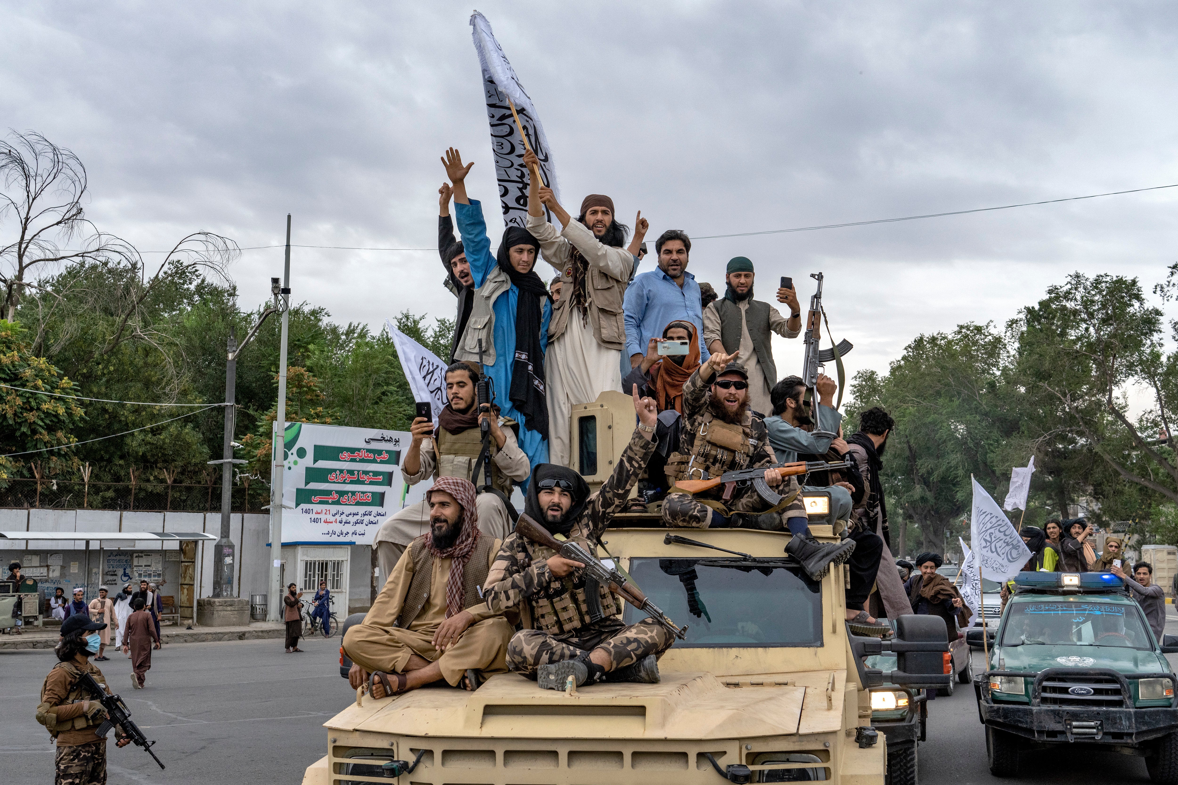 File. Taliban fighters celebrate one year since they seized the Afghan capital, Kabul, in front of the US Embassy in Kabul, Afghanistan, Monday, Aug. 15, 2022